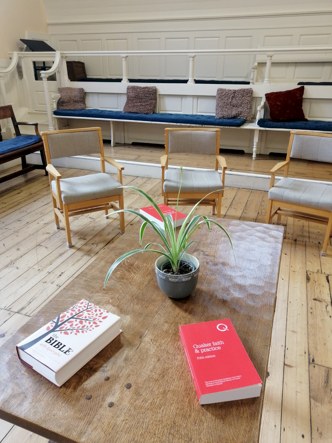 Close of of meeting room table with copies of Faith & Practice